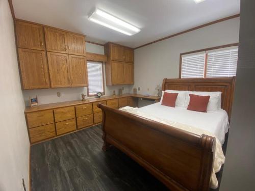 a bedroom with a large bed and wooden cabinets at Best value 3 Huge Bedrooms-Multiple parkings in Willmar