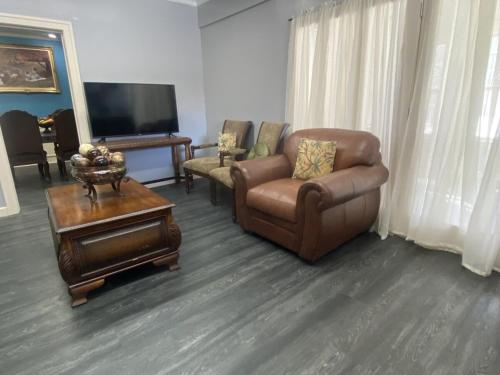 a living room with a couch and a chair and a tv at Best value 3 Huge Bedrooms-Multiple parkings in Willmar