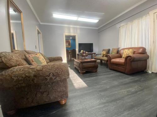 a living room with two couches and a tv at Best value 3 Huge Bedrooms-Multiple parkings in Willmar