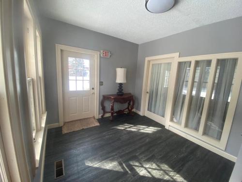 a room with a hallway with a door and a lamp at Best value 3 Huge Bedrooms-Multiple parkings in Willmar