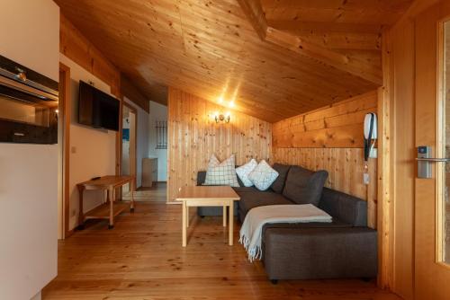 a living room with a couch and a table at Wellnesshaus Reichelt in Radstadt