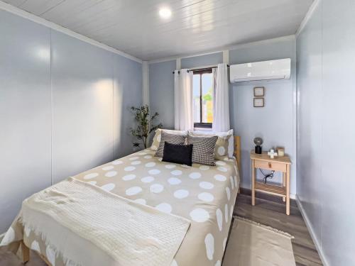 a small bedroom with a bed and a window at Casa Andrés Unique Glamping Stay in Isabela in Jobos