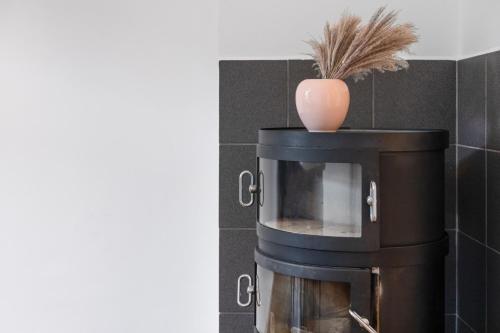 a coffee maker with a vase on top of it at Villa Seeblick 1908 in Bregenz