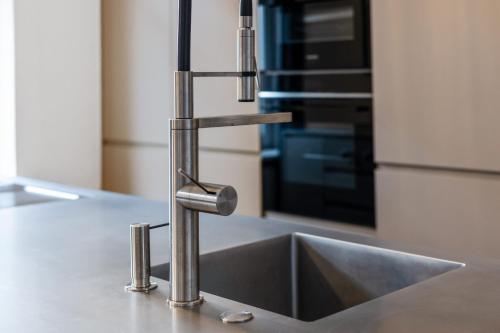 a stainless steel kitchen sink in a kitchen at Villa Seeblick 1908 in Bregenz