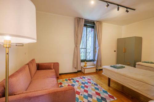 a living room with a couch and a bed at Villa Spa Dalia in Cannobio