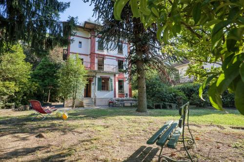 a house with a red chair in front of it at Villa Spa Dalia in Cannobio