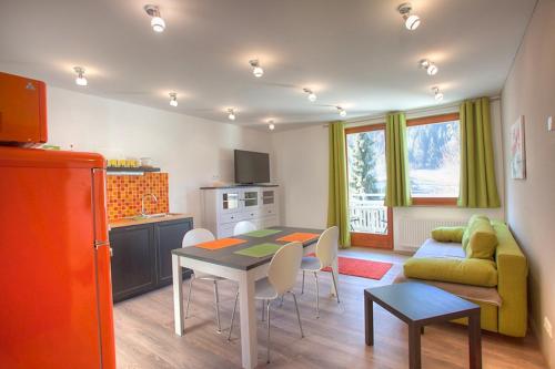 a kitchen and living room with a table and a couch at Ferienwohnung Klamberghof in Feld am See