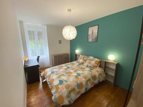 een slaapkamer met een bed en een blauwe muur bij Logement Neuf Cosy avec Espaces Communs Premium 13 in Belfort