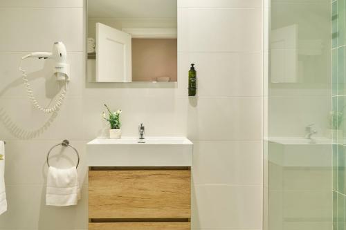 a white bathroom with a sink and a shower at Ona Campanario in La Cala de Mijas