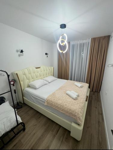 a bedroom with a large bed with a white bedspread at White Home in K'obulet'i