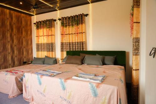 a bedroom with two beds with pink sheets at SS Villa in Trincomalee