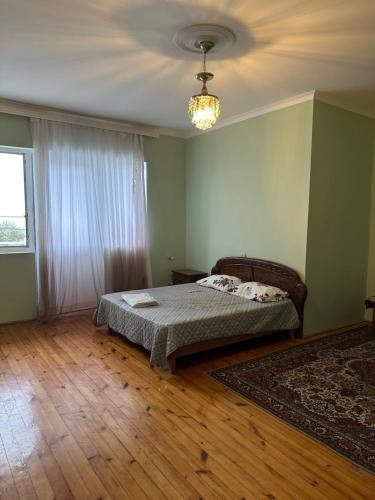 a bedroom with a bed and a chandelier at Ocag hotel in Xaçmaz