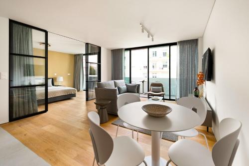 a living room with a table and chairs at Mirabilis Apartments - LX Living in Lisbon