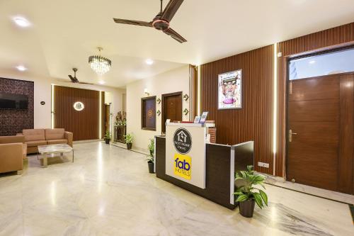 an office lobby with a reception desk and a door at FabHotel Next Home Prime in Gurgaon