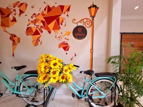 two bikes parked in a room with flowers at Villa Jogja Tropical in Yogyakarta