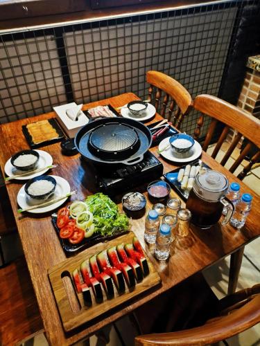 a wooden table with food on top of it at Villa Jogja Tropical in Yogyakarta