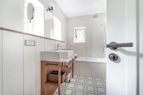 a white bathroom with a sink and a shower at Villa Arthus-Bertrand in Noirmoutier-en-l'lle