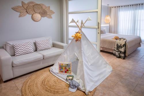 a living room with a bed and a play tent at Serhs Natal Grand Hotel & Resort in Natal