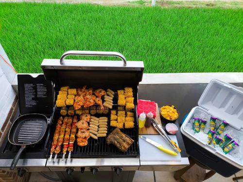 a grill with a bunch of different types of food on it at Villa Jogja Tropical in Yogyakarta