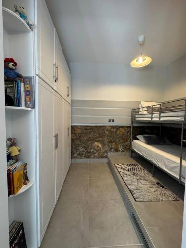 a room with two bunk beds and a hallway at Kastoria Book House with yard in Kastoria