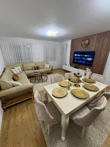 a living room with a white table and chairs at Duplex City Center Gjakove in Gjakove
