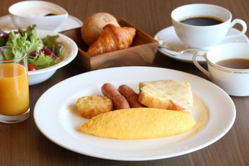 a table with a plate of breakfast food and coffee at Hotel Marroad Hakone in Hakone