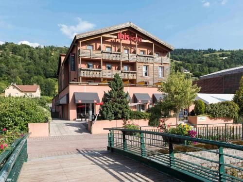 a building with a sign on the side of it at ibis La Bresse Gérardmer in La Bresse