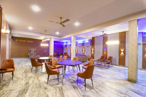 a lobby with tables and chairs in a room at FabHotel Next Home Prime in Gurgaon