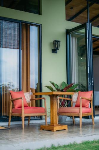 a wooden table with two chairs and a table at Idal Villa in Idalgashinna