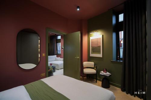a bedroom with a bed and a mirror at Malva at The Heim Residences in Manchester