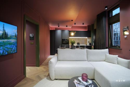 a living room with a white couch and a kitchen at Malva at The Heim in Manchester