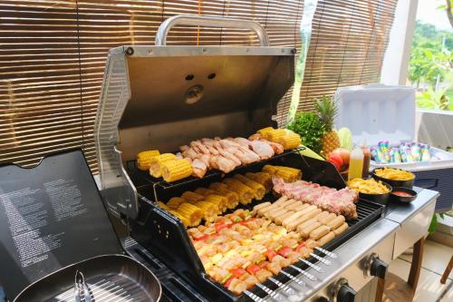 a grill with a bunch of different types of food at Villa Jogja Tropical in Yogyakarta