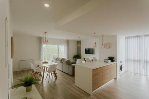 a kitchen and living room with a table and chairs at Best Houses 70 - Green Holidays in Serra de El-Rei