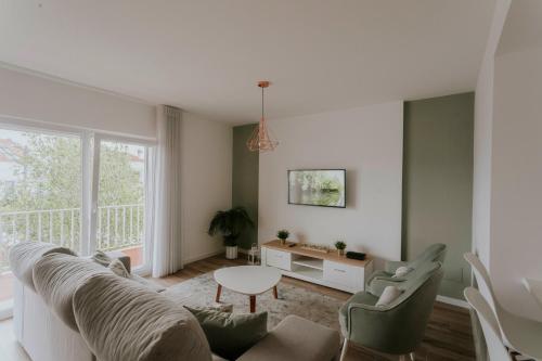 a living room with a couch and chairs and a table at Best Houses 70 - Green Holidays in Serra de El-Rei
