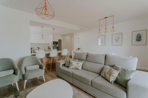 a living room with a couch and chairs and a kitchen at Best Houses 70 - Green Holidays in Serra de El-Rei