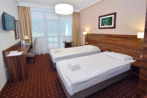 Postel nebo postele na pokoji v ubytování Hotel Podium