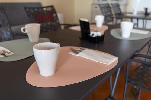 a table with a cup and a napkin on it at La Villetta nel Parco in La Giustiniana