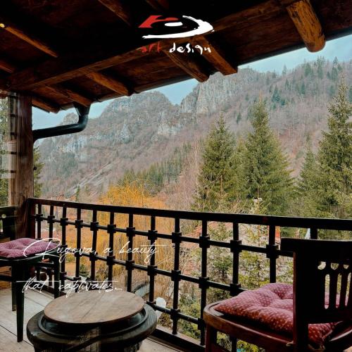 a balcony with a table and chairs and a view at Whispering Pines Villa in Peje