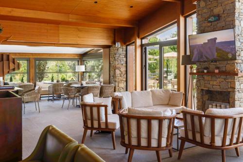 a living room with chairs and a stone fireplace at Regnum Banya Thermal Hotel in Banya