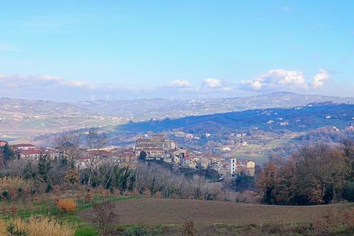 a town on top of a hill with houses at Parva Domus in Campolattaro