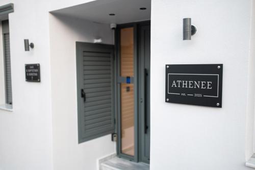 a sign that reads entrance on the side of a building at Athenee in Preveza