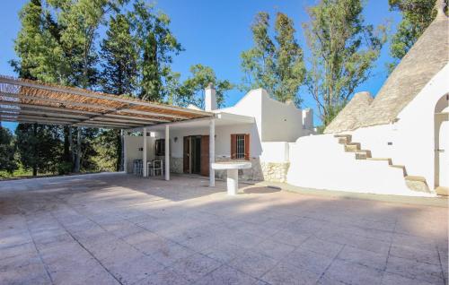 a patio with a table and stairs to a house at Cozy Home In Ceglie Messapica in Ceglie Messapica