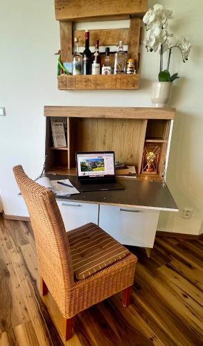 an office with a desk with a laptop and a chair at Lipno Villa Beach - Lipno Stausee - Lakeside in Loučovice