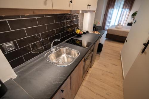 a kitchen with a sink and a counter top at Athenee in Preveza