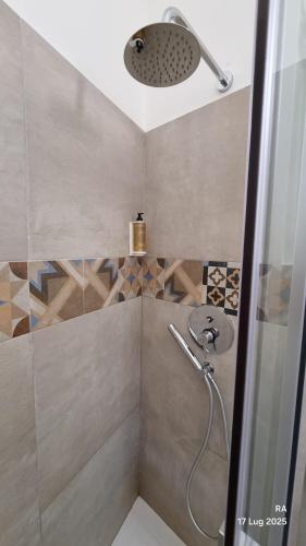 a shower with a shower head in a bathroom at Vacanze da Beppuccio Scoglitti in Vittoria