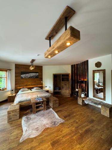 a bedroom with a large bed and a wooden ceiling at bouda Pod Sněžkou in Pec pod Sněžkou