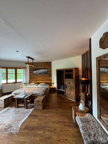 a bedroom with a large bed and a table at bouda Pod Sněžkou in Pec pod Sněžkou
