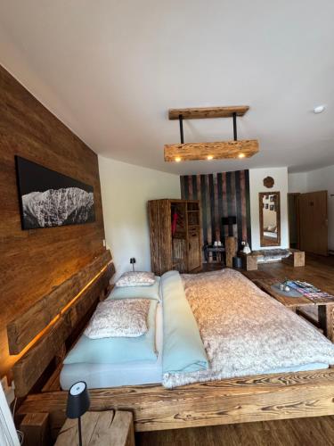 a bedroom with a large bed with a wooden headboard at bouda Pod Sněžkou in Pec pod Sněžkou