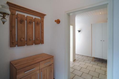 a kitchen with a wooden cabinet and a hallway at Ferienwohnungen Traumschloss in Wernigerode