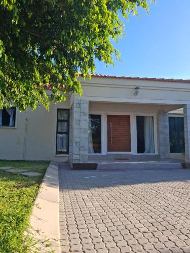 a house with a brick driveway in front of it at House6705 Air B&B in Maun Airport